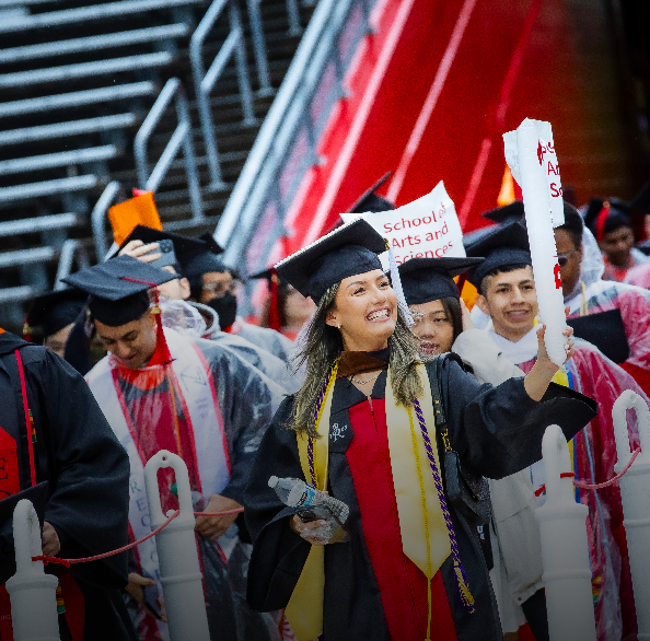 picture of students in cap and gown celebrating commencement at Rutgers