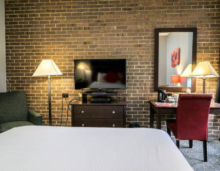 tv lamp chair and desk in guest room
