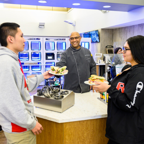 students receiving their food from dining hall
