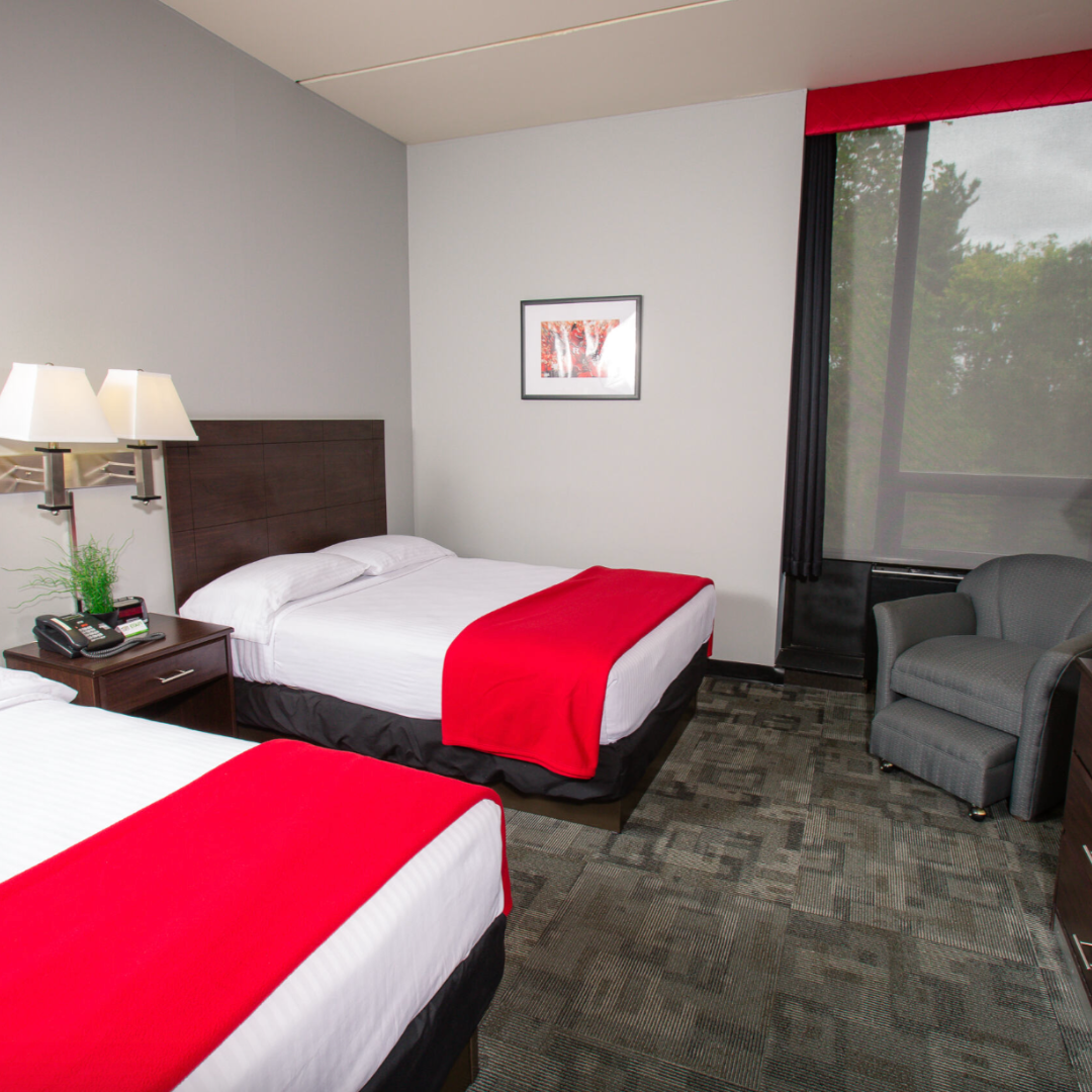 photo of guest rooms with two double beds decorated with red, white, and black